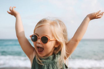 Young girl happy face and arms in air